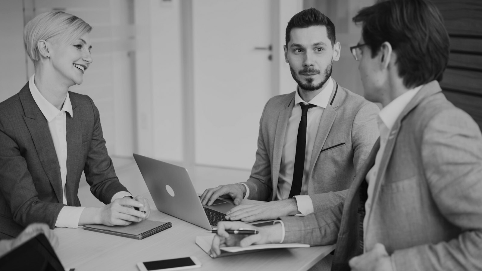 Business professionals in a meeting around a table